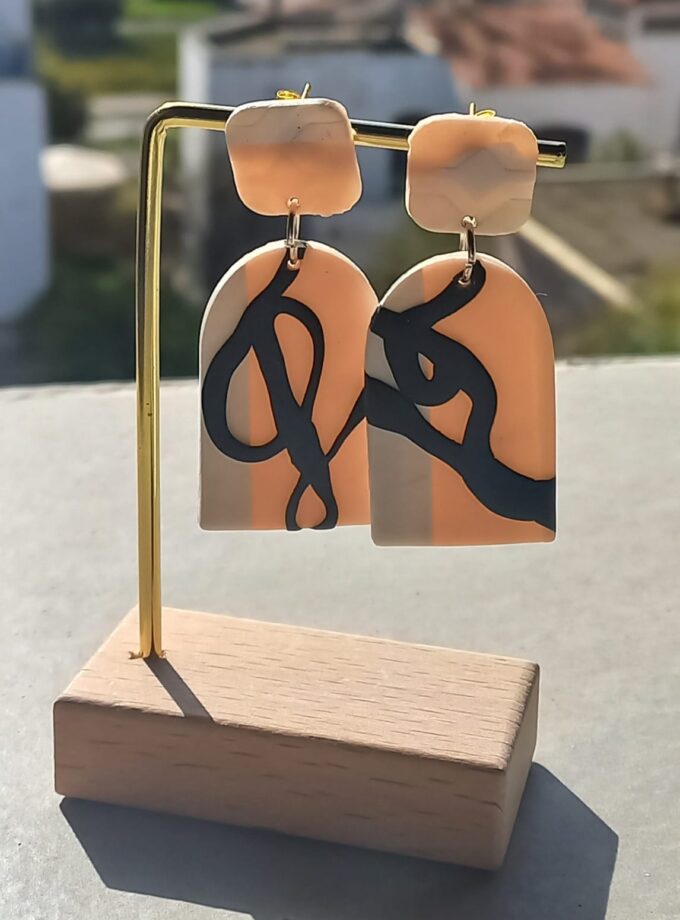 Trace handmade polymer clay earrings featuring blush pink, ivory, and black abstract line art design.